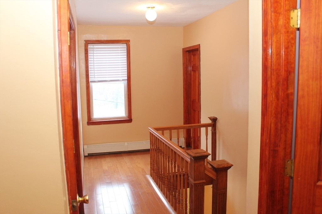 618 Harvard Street Boston, MA 02126 - Photo 34 of 42 a view of hallway with stairs and a window
