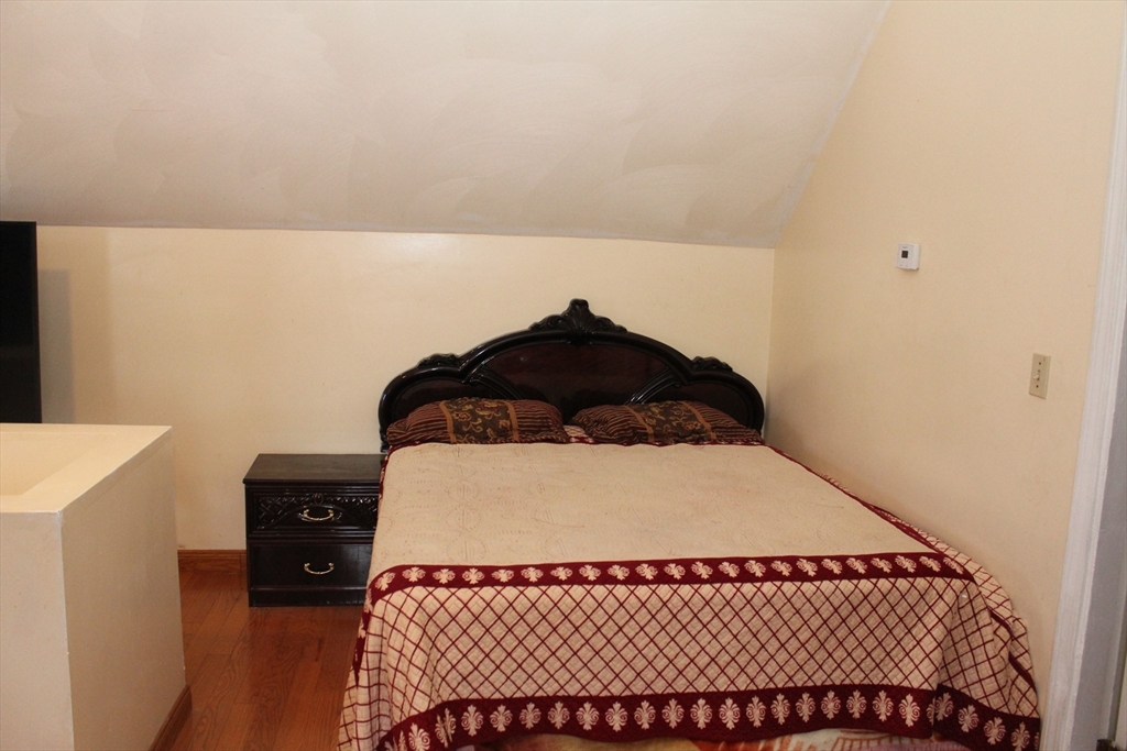 618 Harvard Street Boston, MA 02126 - Photo 38 of 42 a bedroom with a bed and a window