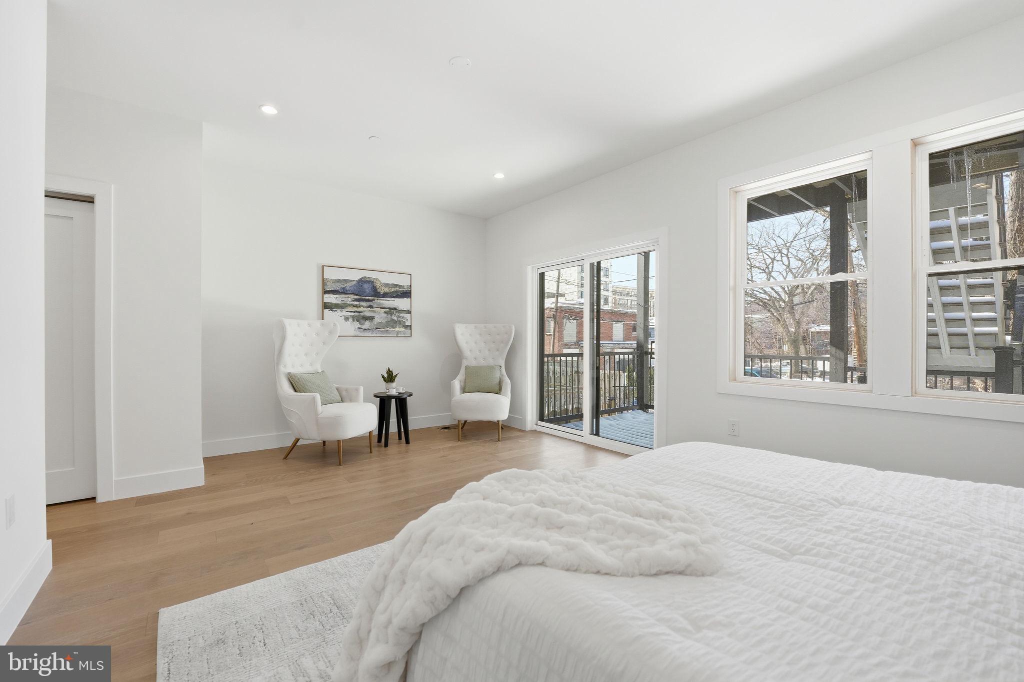 3916 8th Street Northwest, Unit B Washington, DC 20011 - Photo 12 of 24 a spacious bedroom with a large bed and a large window