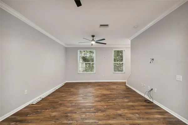 wooden floor in an empty room with a window