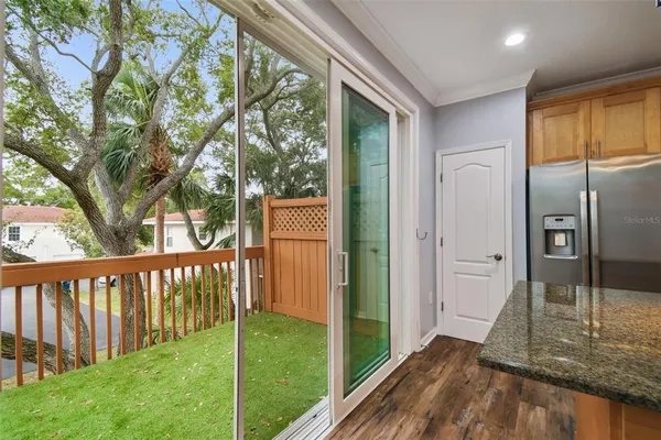 a view of a porch with a floor to ceiling window and wooden fence