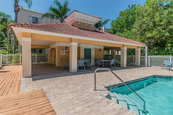 a front view of a house with a yard table and chairs