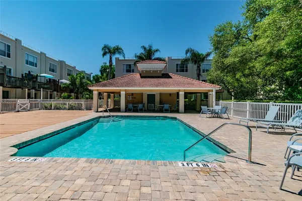 a view of house with swimming pool outdoor seating