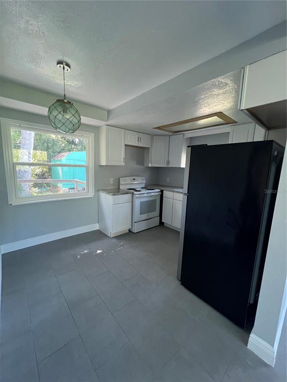7222 Tropical Drive Weeki Wachee, FL 34607 - Photo 19 of 23 a kitchen with furniture and window