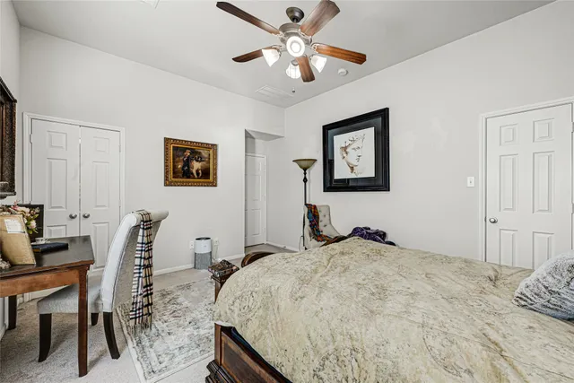 a bedroom with a bed a desk and chair