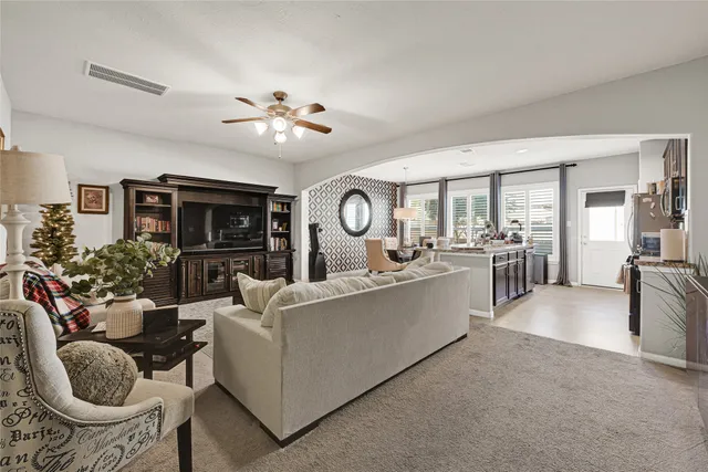 a living room with furniture a dining table and a fireplace