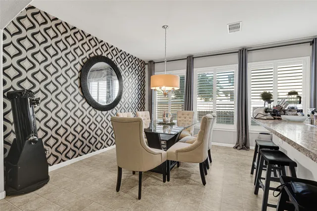 a dining room with furniture a rug and a large window