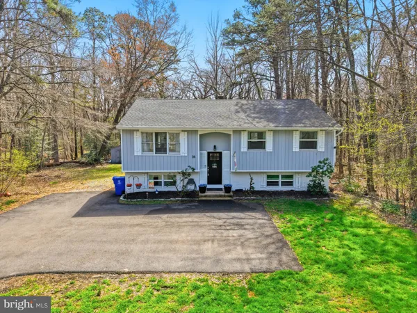 a view of a house with patio and a yard