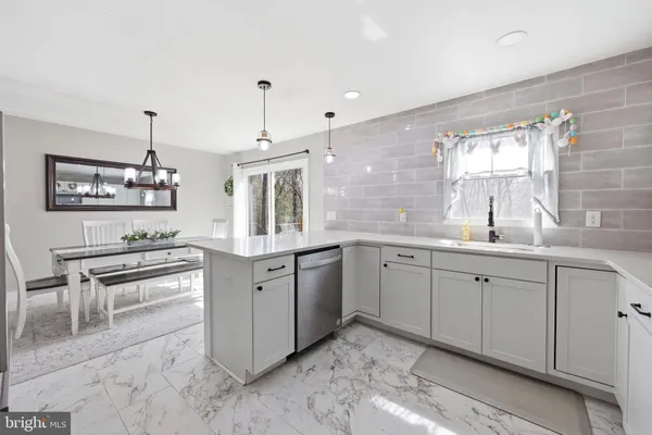 a large white kitchen with cabinets