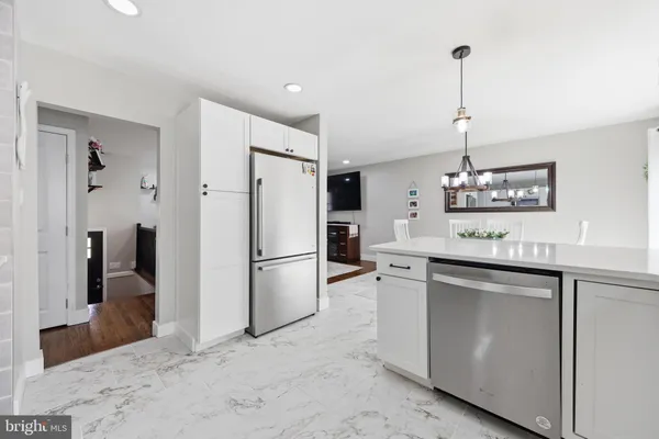 a kitchen with a refrigerator a sink and dishwasher