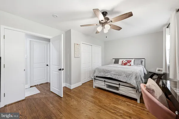 a bed room with a bed and a ceiling fan