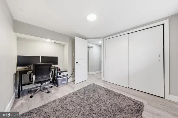 a view of a workspace with furniture and a window