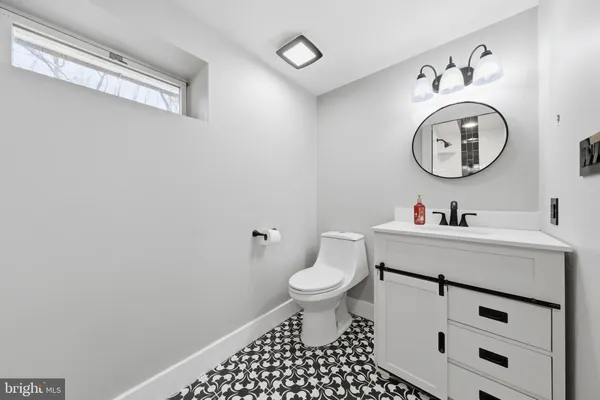 a bathroom with a sink mirror and toilet