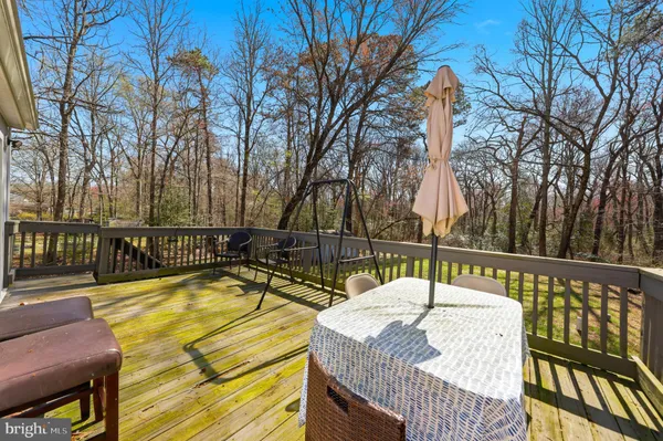 a view of a swimming pool with a patio and deck