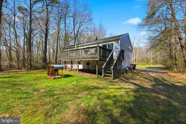 a view of a house with backyard porch and sitting area