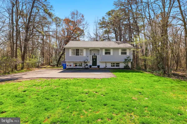 a view of a house with a yard porch and sitting area