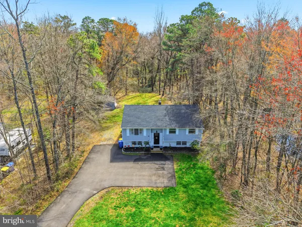 a pathway of a house with a yard