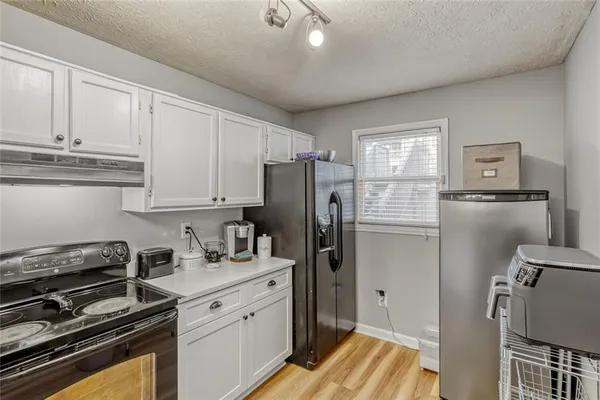 a kitchen with a refrigerator stove and sink