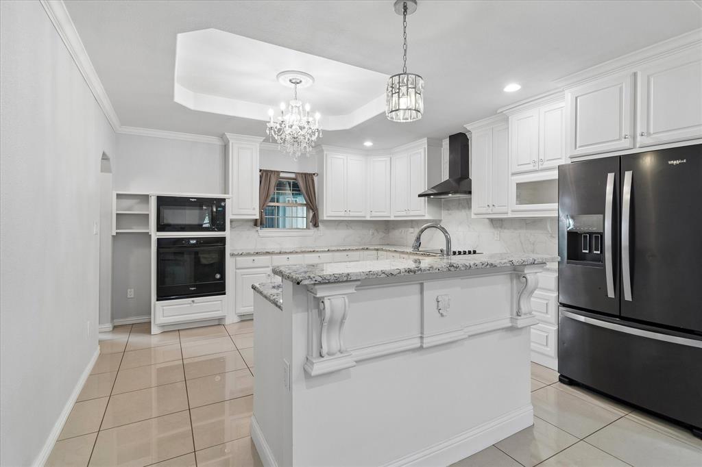 3007 McReynolds Road Sanger, TX 76266 - Photo 20 of 39 Contemporary kitchen featuring white cabinetry, light-toned tile flooring, and contrasting black appliances