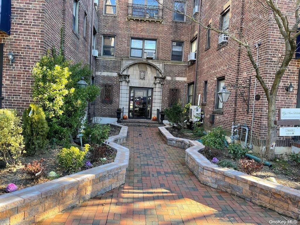 a front view of a house with yard and outdoor seating