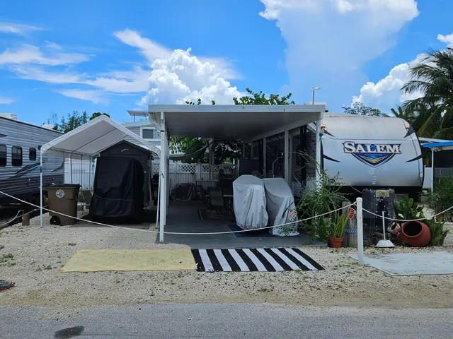 a view of a chairs and table in backyard