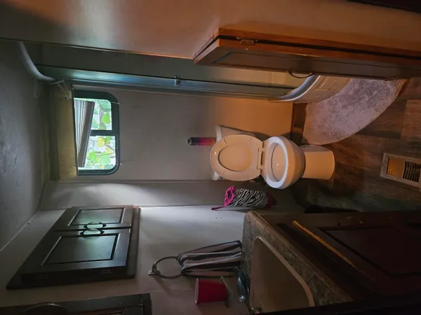 a bed sitting in a spacious bedroom next to a window