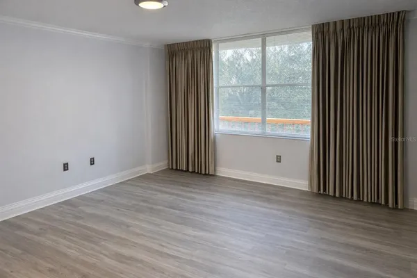 a view of an empty room and wooden floor