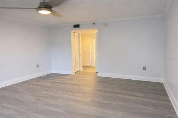 a spacious bedroom with a bed and a chandelier