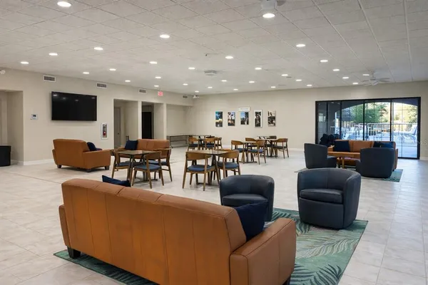 a living room with lots of furniture a dining table and a flat screen tv