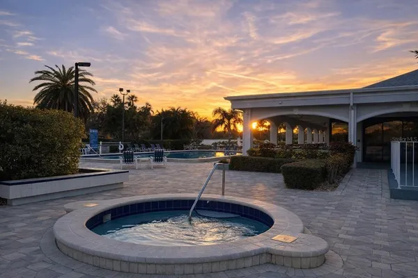 a view of a swimming pool with outdoor seating