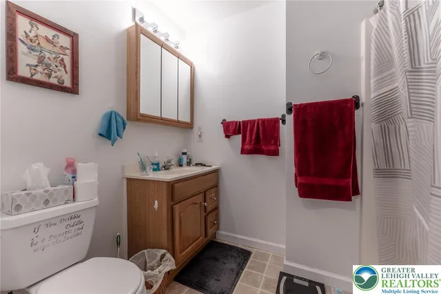 a bathroom with a toilet and a shower curtain