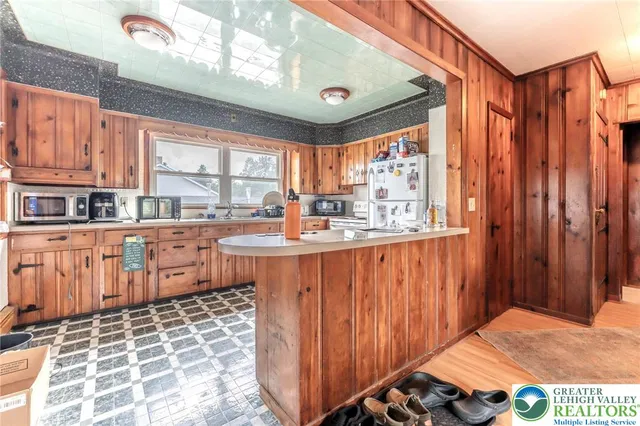 a kitchen with granite countertop a refrigerator and a stove top oven