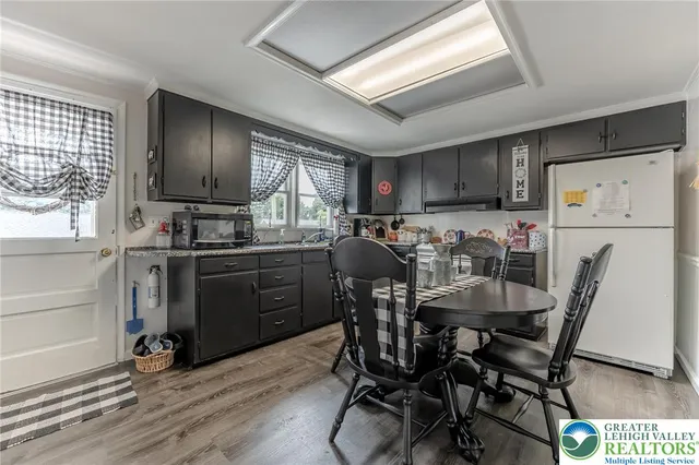 a kitchen with granite countertop a sink a stove and a microwave