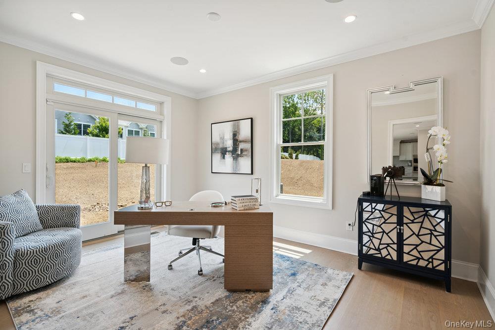 48 Plainview Road Woodbury, NY 11797 - Photo 11 of 49 a living room with furniture a table and a window