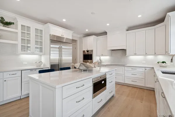a large white kitchen with a large window