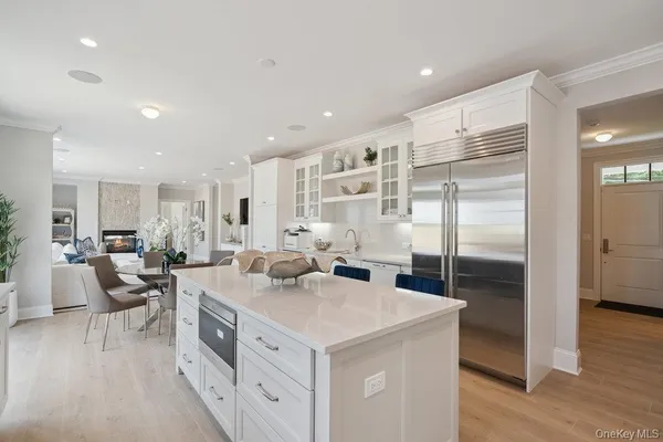 a kitchen with appliances a sink and cabinets