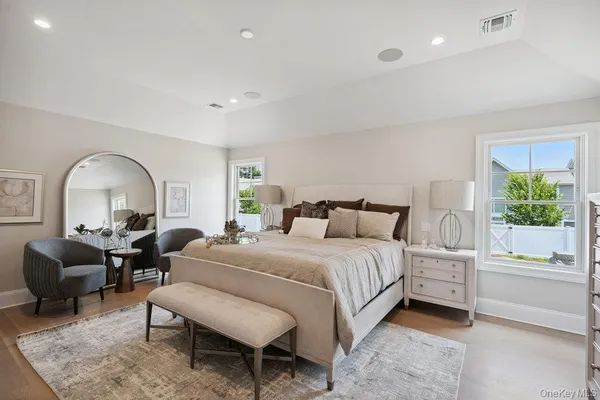 a bedroom with a bed large window and a couch
