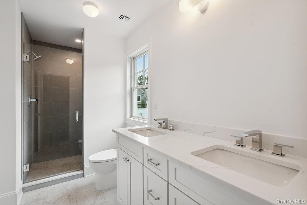 48 Plainview Road Woodbury, NY 11797 - Photo 33 of 49 a bathroom with a sink and a mirror