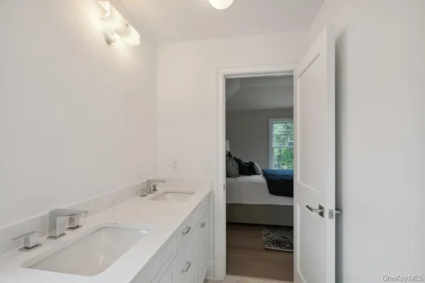 a spacious bedroom with a bed and a large window