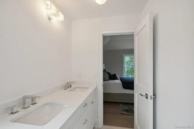 a spacious bedroom with a bed and a large window