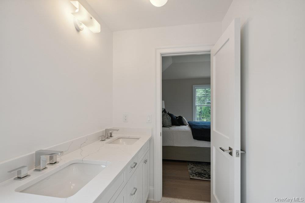 48 Plainview Road Woodbury, NY 11797 - Photo 34 of 49 a en suite bathroom with a sink and a mirror