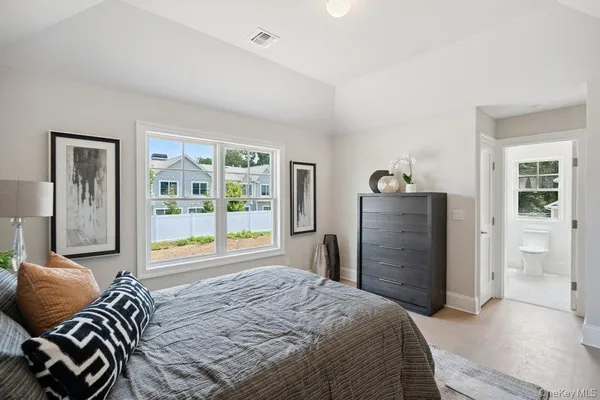 a view of a hallway with bedroom and wooden floor