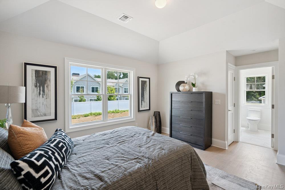 48 Plainview Road Woodbury, NY 11797 - Photo 36 of 49 a bedroom with a bed and dresser with mirror