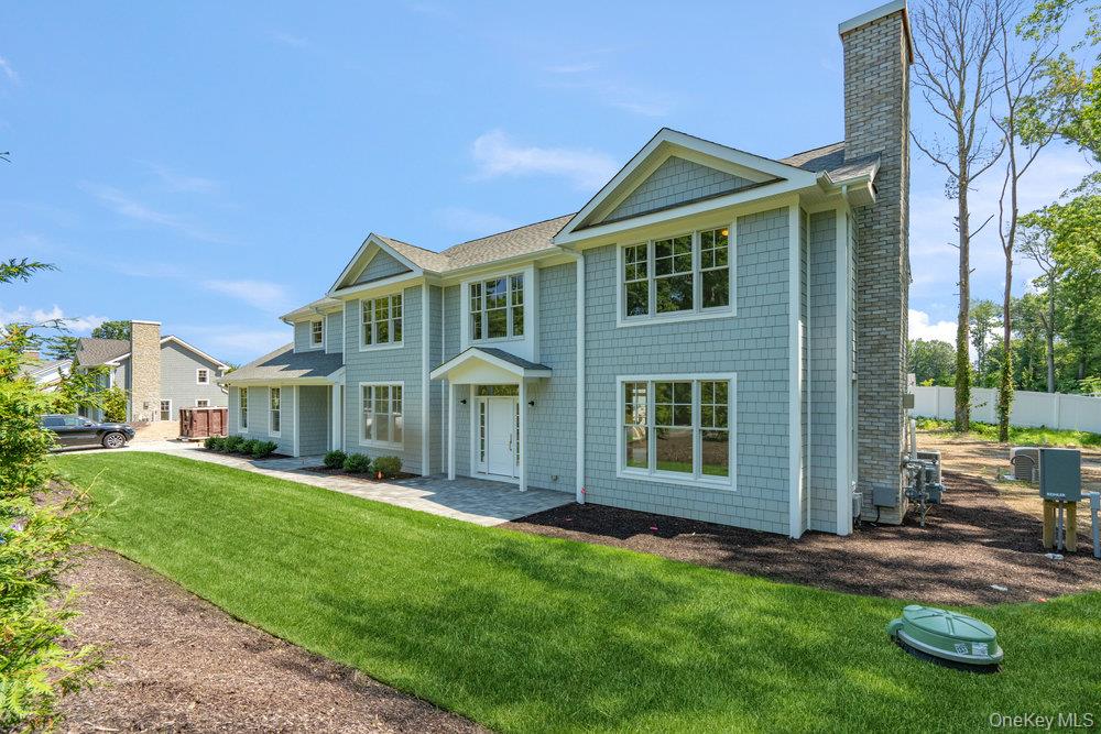 48 Plainview Road Woodbury, NY 11797 - Photo 4 of 49 front view of a house with a yard