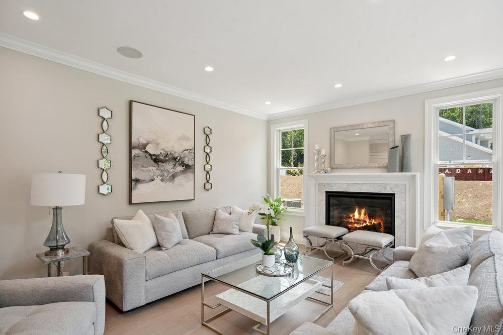 48 Plainview Road Woodbury, NY 11797 - Photo 10 of 49 a living room with furniture and a fireplace