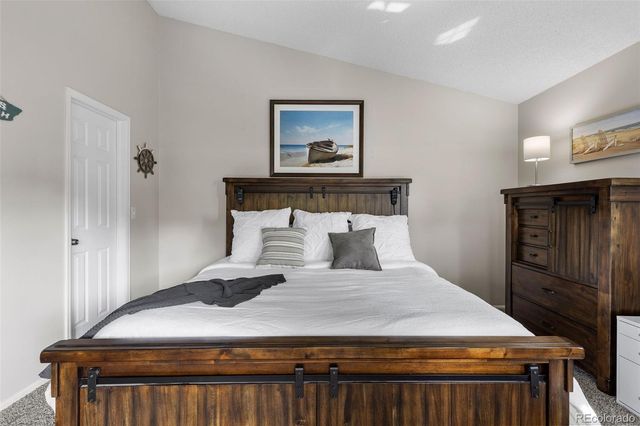 a bedroom with a bed and a dresser