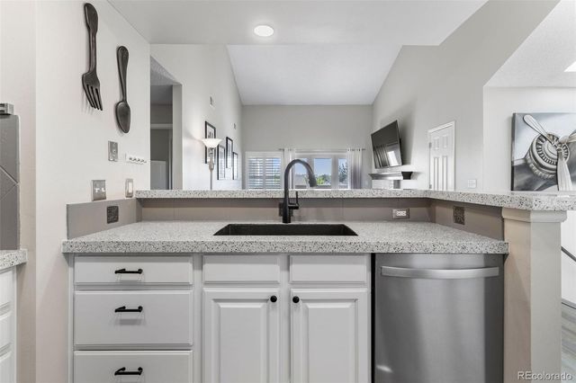 a kitchen with stainless steel appliances granite countertop a sink and cabinets