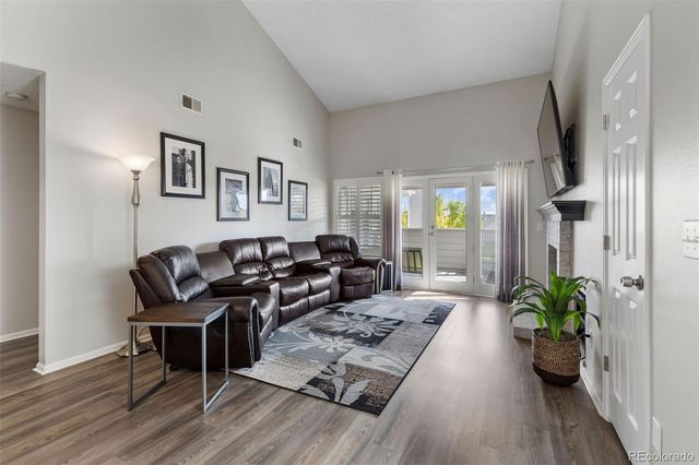 a living room with furniture potted plant and a window