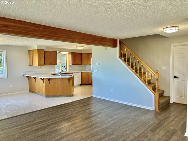 a view of kitchen with wooden floor and electronic appliances
