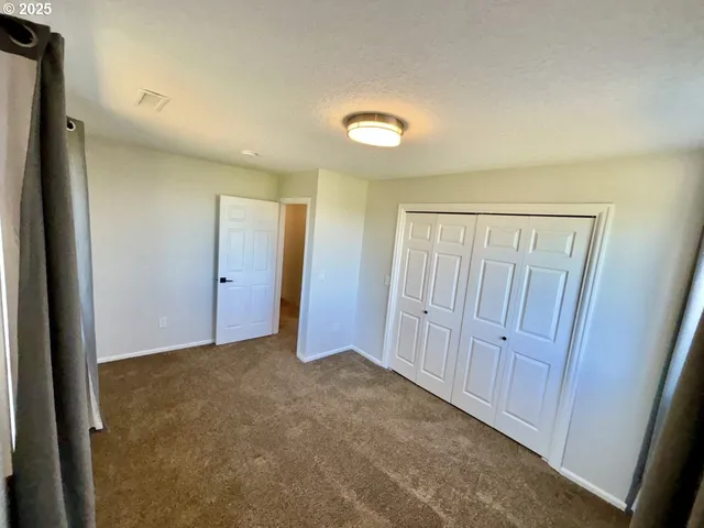 an empty room with closet area
